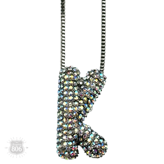 Rhinestone letter pendant on silver necklace