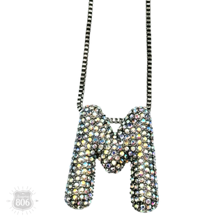 Rhinestone letter pendant on silver necklace